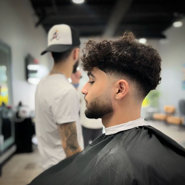 Textured curls with a tight fade