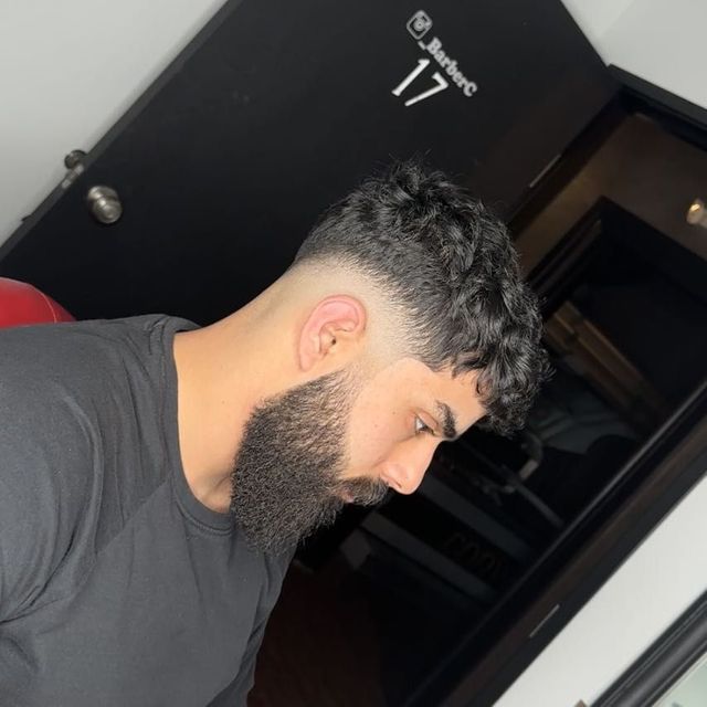 Tapered haircut with a clean beard blend