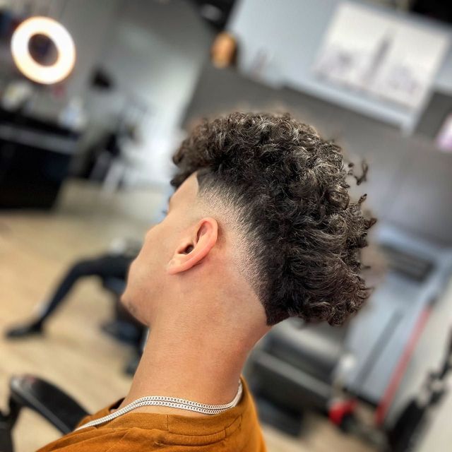 Copper curls shaped over a clean fade